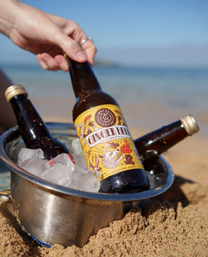 Waves & Caves Ginger Beer bottle being lifted from an ice bucket on the beach, Margaret River WA